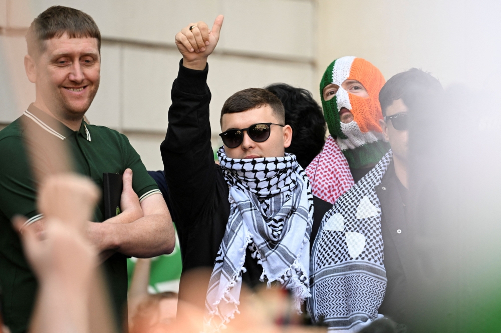 Hundreds rally behind Kneecap’s Mo Chara as he faces UK terrorism charge for Hezbollah flag display