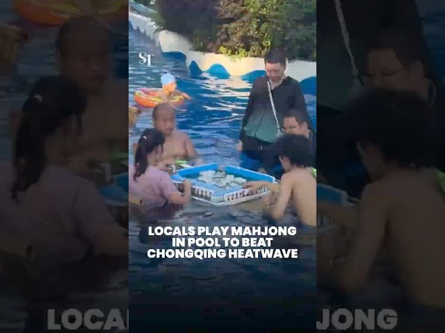 Locals play mahjong in pool to beat Chongqing heatwave