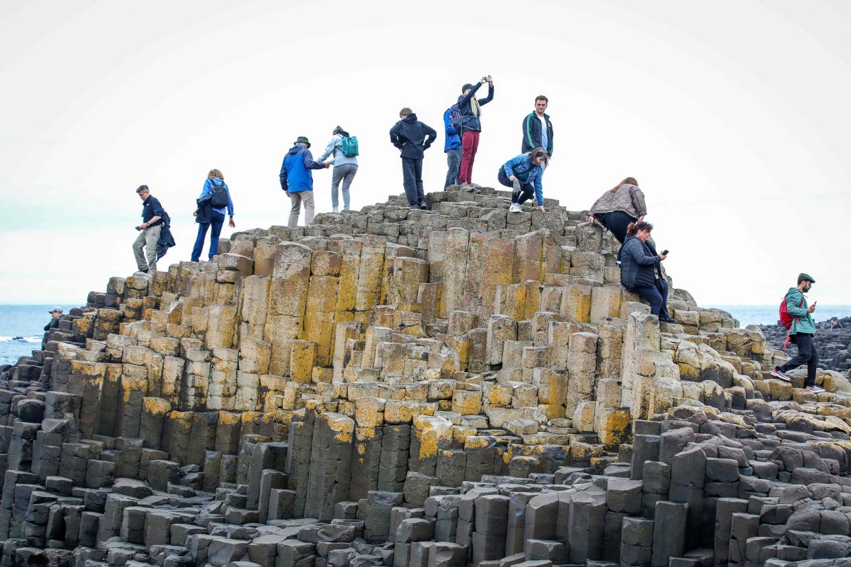 Tourists told to stop shoving coins into rocks at Giant's Causeway
