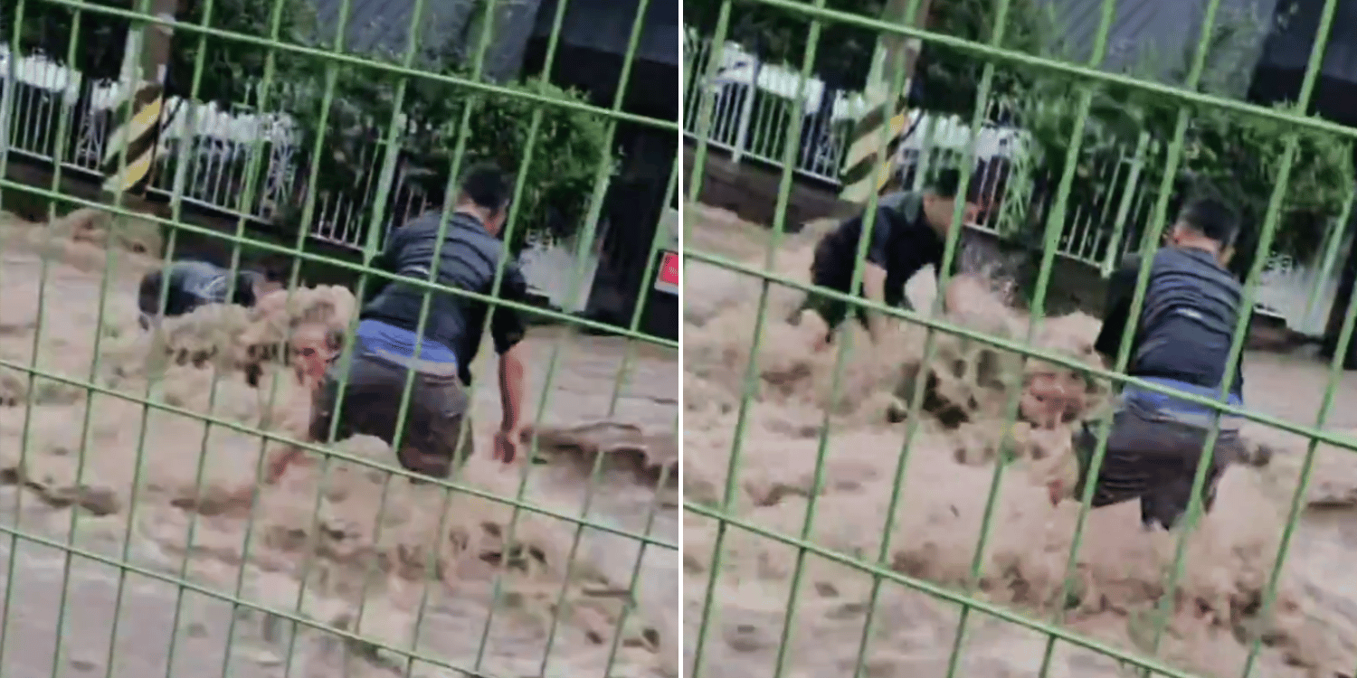 Men battle raging floodwaters in korea for 20 minutes to rescue senior trapped in manhole