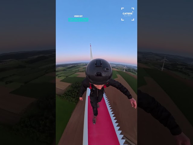 DAREDEVIL RUNS AND JUMPS OFF A WIND TURBINE BLADE
