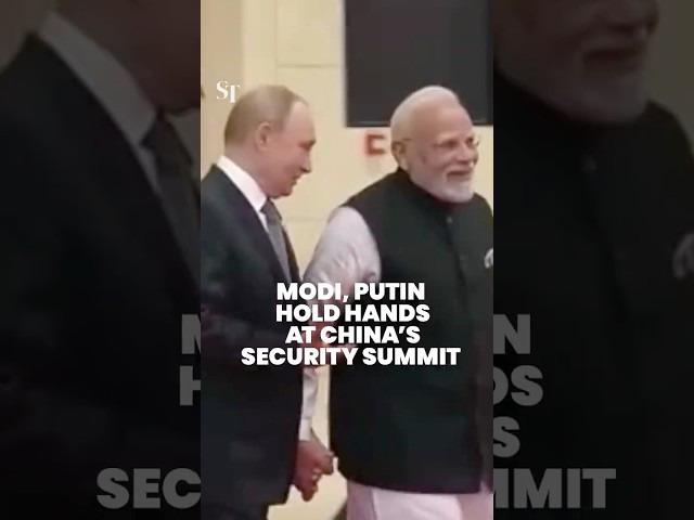Indian PM Narendra Modi and Russian President Vladimir Putin hold hands at China summit
