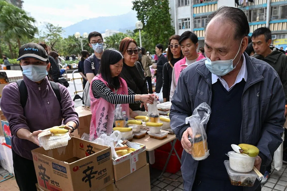 ‘Very worried’: Hong Kong fire survivors hunt for the missing