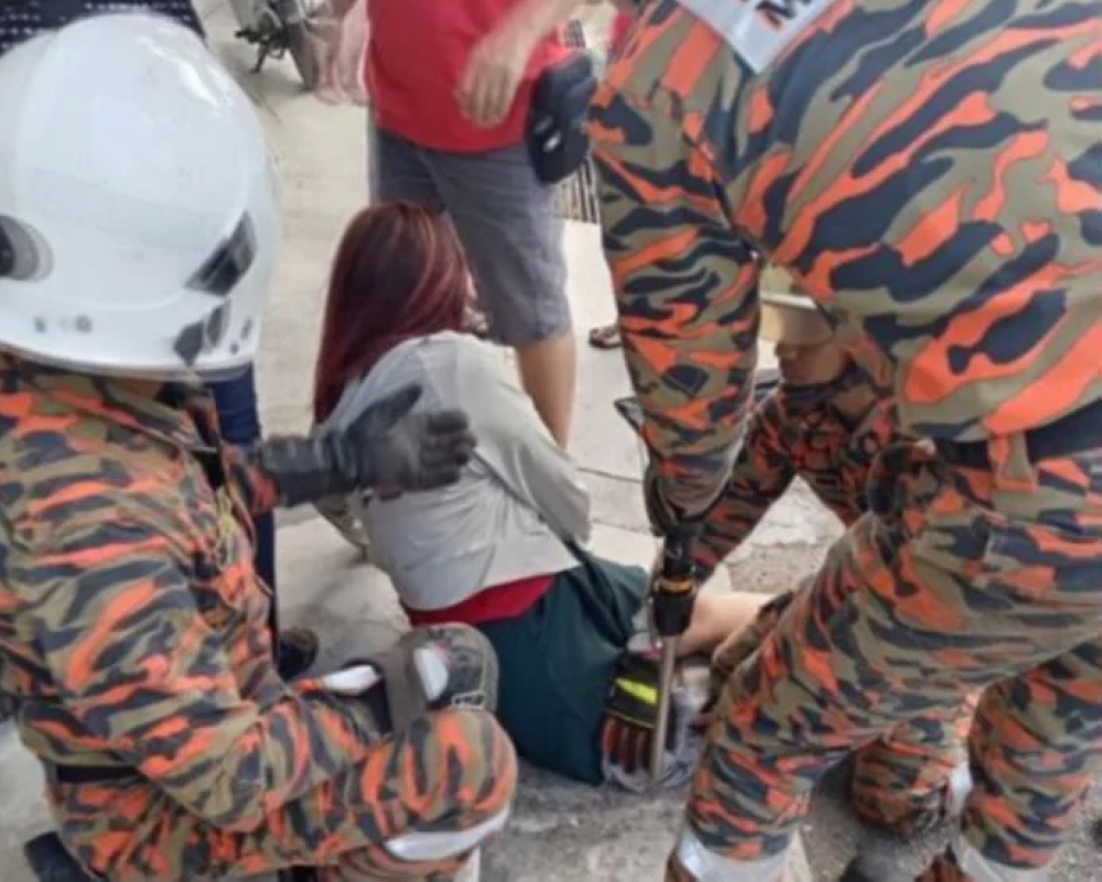 Penang firefighters free woman after leg caught in drain cover