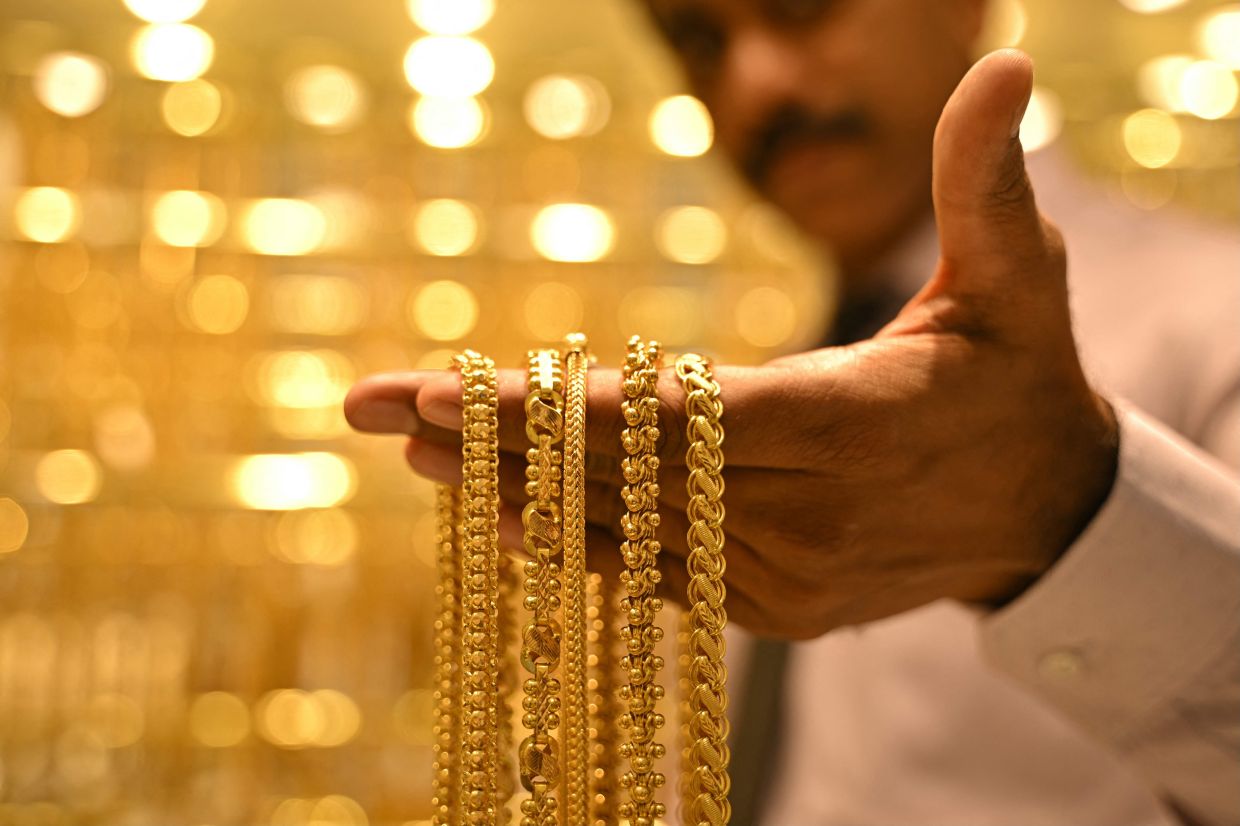 Gold falls to over one-month low on firm dollar, hawkish Fed